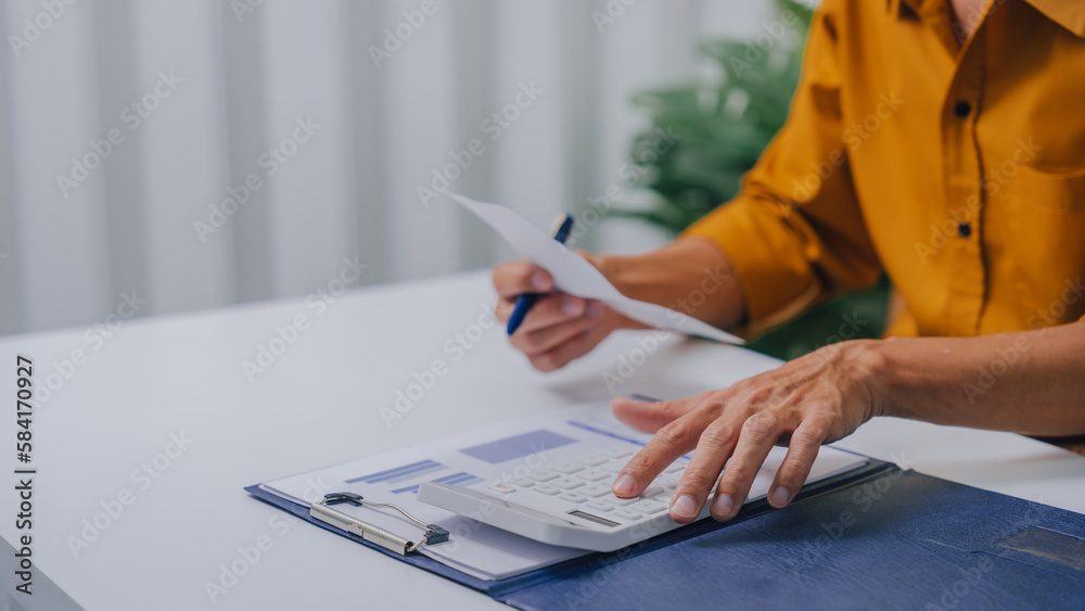 Fototapeta premium Young Serious asia people bookkeeper doing bookkeeping entrepreneur small business owner accountant in office with balance sheet, income tax return and budget of local business.