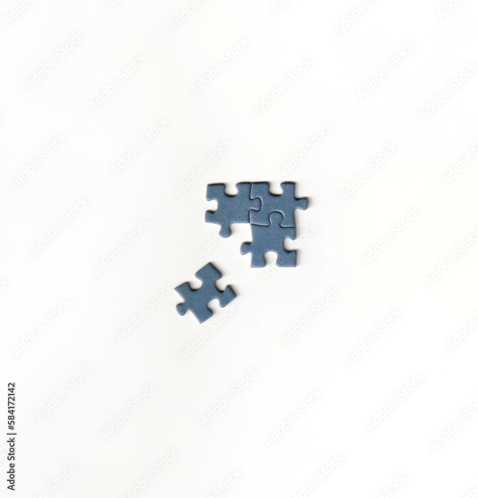 Unfinished jigsaw puzzle pieces on a white background depicting teamwork and problem solving puzzle day