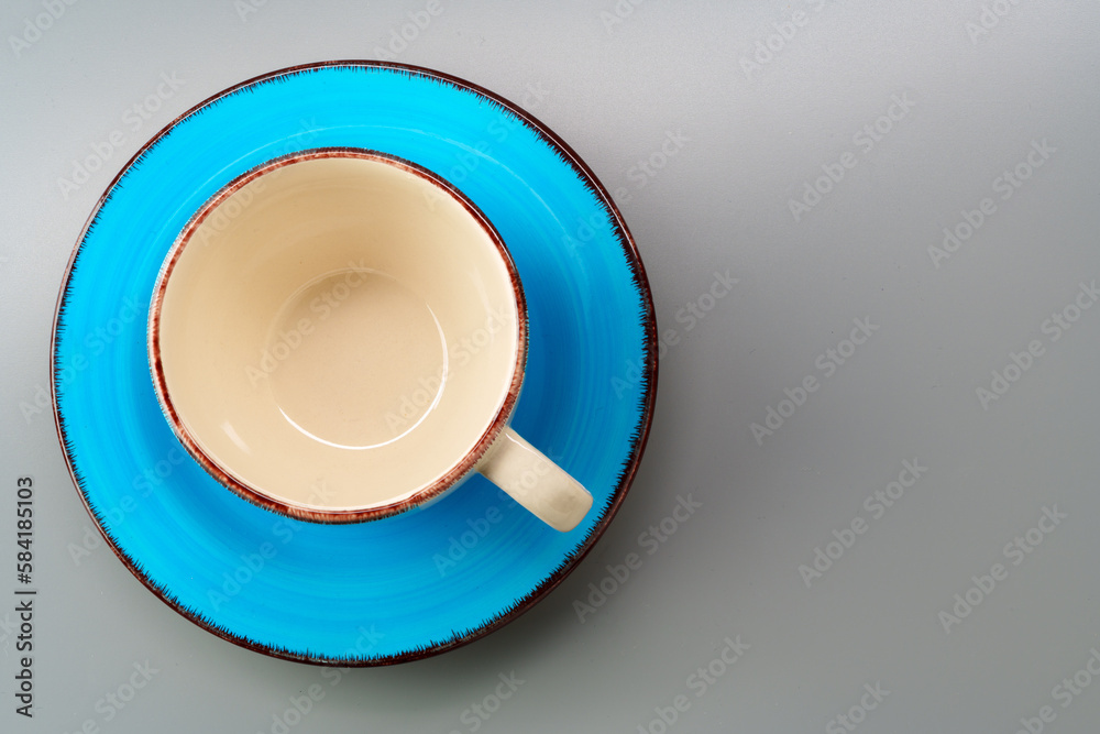 Top view of ceramic cup with saucer on gray background Top view of ceramic cup with saucer on gray background