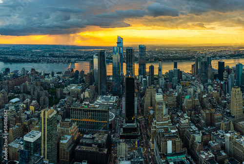 A rain storm over the Hudson Yards in New York City during beautiful sunset.