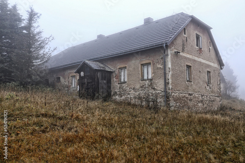Old house with wooden porch in the autumn fog © ondrejschaumann