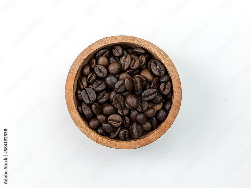 top view of coffee beans in wooden bowl isolated on white
