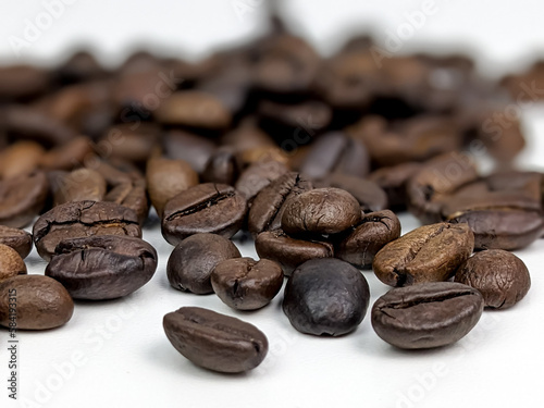 scattered coffee beans isolated on white with selected focus