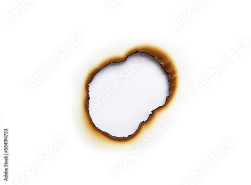 burned hole on a white paper background photo