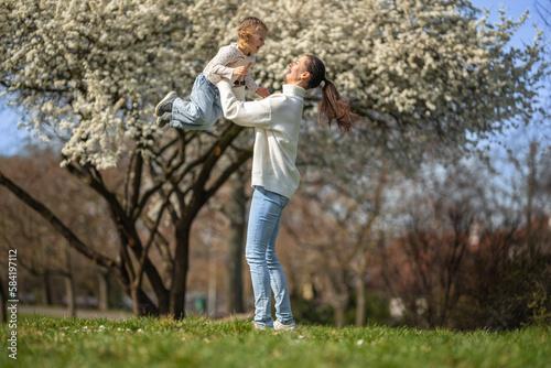 Young mother and her cute daughter having a fun in spring time park in Prague, Europe © dtatiana