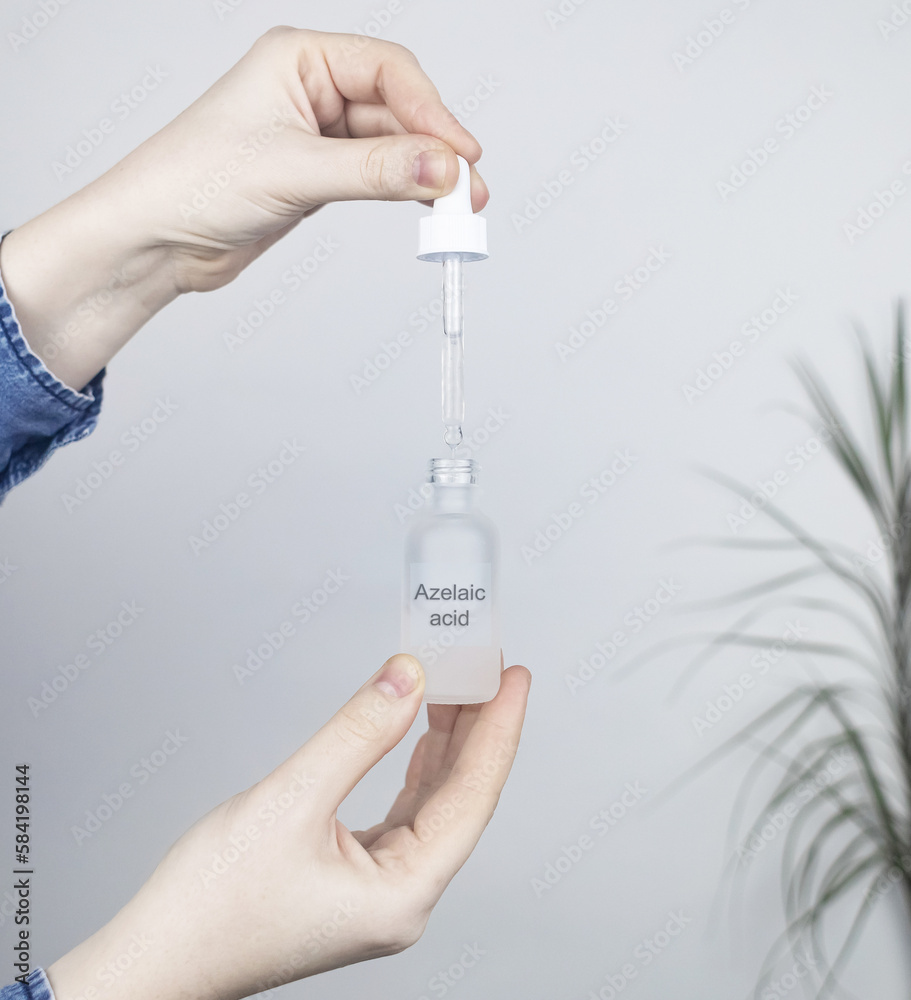 Azelaic acid. The girl applies azelainates to her face. Laboratory ...