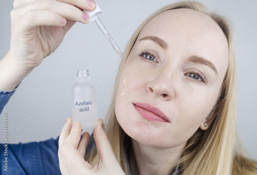 Azelaic acid. The girl applies azelainates to her face. Laboratory research. Facial skin care