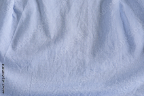 Crumpled light blue fabric as background, top view