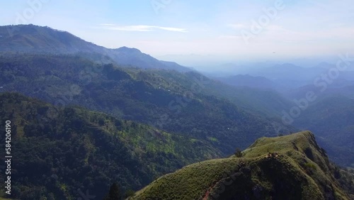 Aerial view from above of beautiful mountains and rocks.  . Calm beautiful video of a flight over the hills on the background for tourism, design and advertising