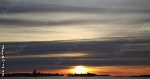 Sunset at Laajasalo, Suomelinna in the background, in winter, Helsinki, Finland. photo