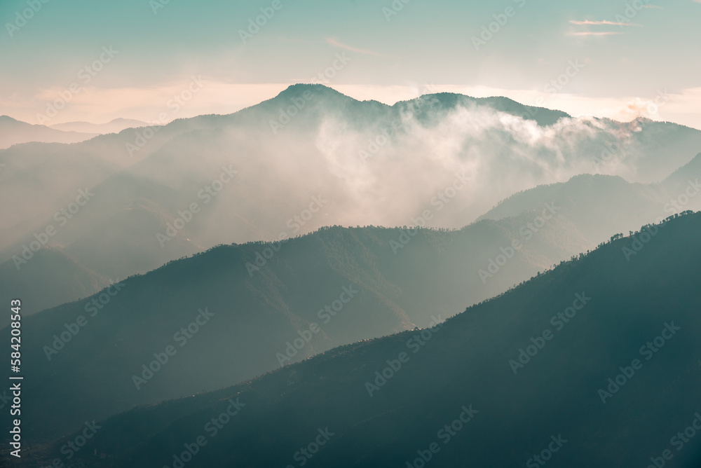 Layers of mountains peaks covered in Fog