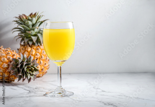 pineapple juice in a glass on a light table