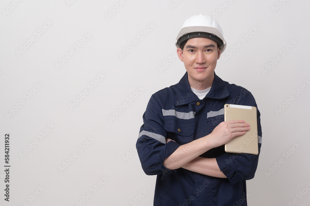 Portrait of male engineer wearing a protective helmet over white background studio.