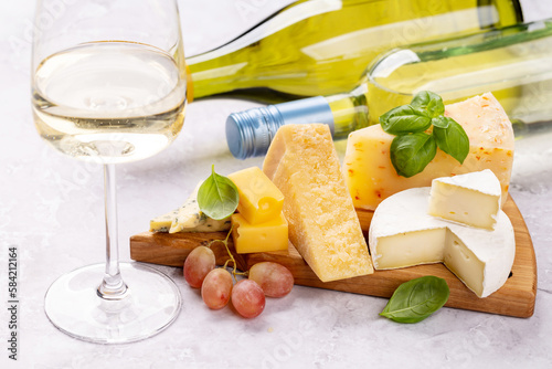 Various cheese on board and wine