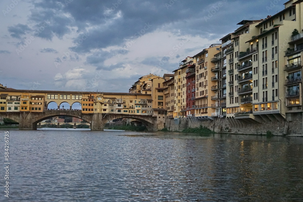 Fototapeta premium Ponte Vecchio at sunset seen from a boat on the Arno River in Florence, Tuscany, Italy