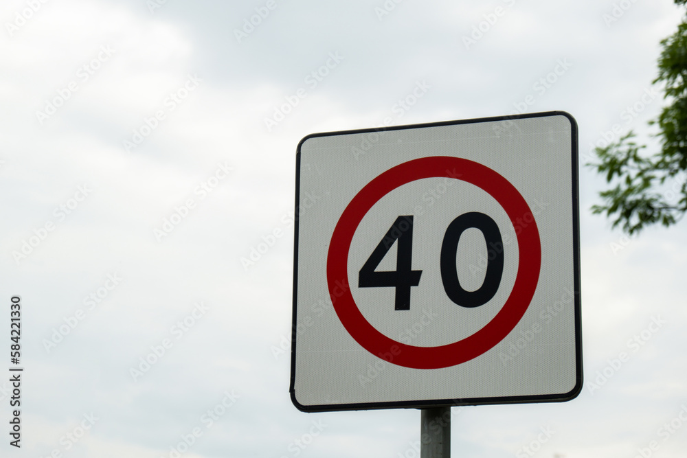 Speed limit sign with blue sky background. European Speed limit sign 40 km per hour. City zone attention road sign. Outdoor traffic sign Speed limit sign with blue sky background. European Speed limit sign 40 km per hour. City zone attention road sign. Outdoor traffic sign