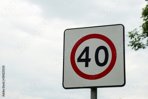 Speed limit sign with blue sky background. European Speed limit sign 40 km per hour. City zone attention road sign. Outdoor traffic sign photo