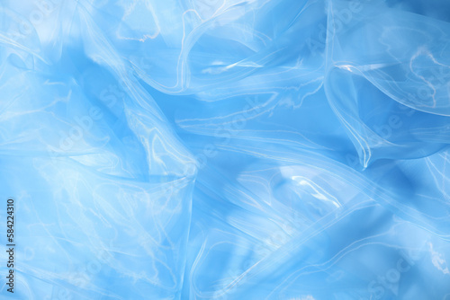 Beautiful light blue tulle fabric as background  closeup