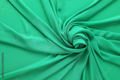 Beautiful green tulle fabric as background, top view