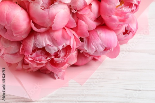 Fototapeta Naklejka Na Ścianę i Meble -  Bouquet of beautiful pink peonies on white wooden table, closeup