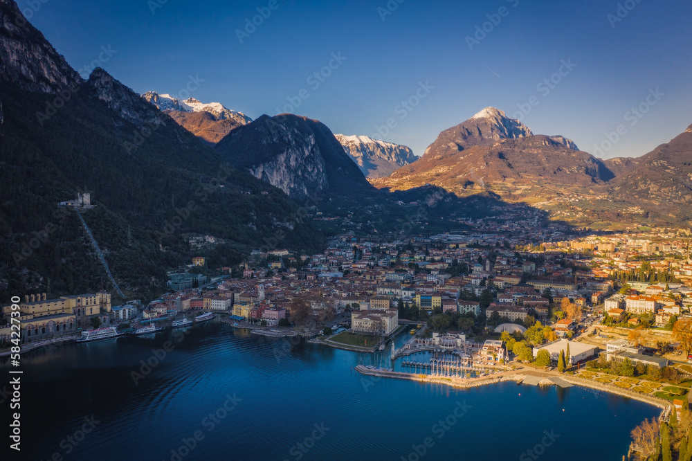 The city of Riva del Garda, situated in the northern part of the largest Italian lake, Lago di Garda. Panoramic aerial view in January 2023