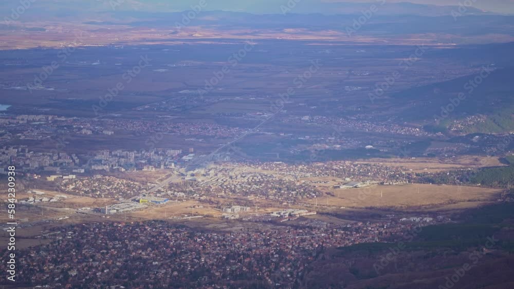 Handheld overview of Sofia city and towns at base of mountains and hills Handheld overview of Sofia city and towns at base of mountains and hills