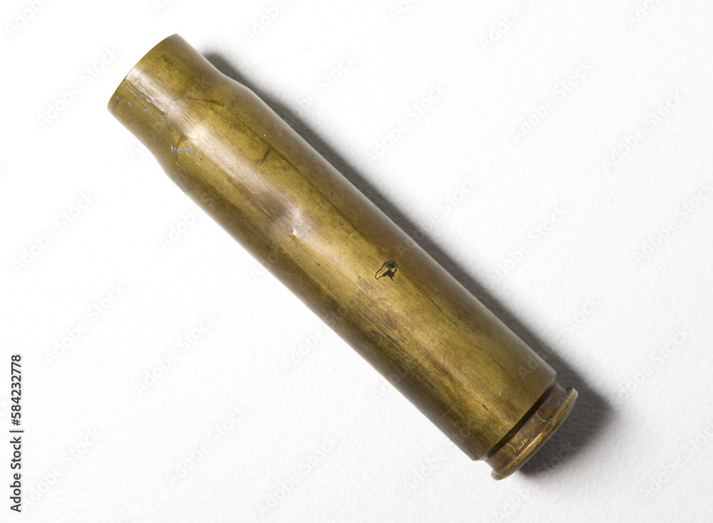 A spitfire 1942 20mm R.H cannon shell world war 2 empty used bullet casing. British aviation warplane ammunition. Iconic british historical history object. A spitfire 1942 20mm R.H cannon shell world war 2 empty used bullet casing. British aviation warplane ammunition. Iconic british historical history object.
