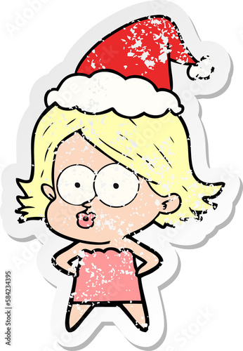distressed sticker cartoon of a girl pouting wearing santa hat © lineartestpilot