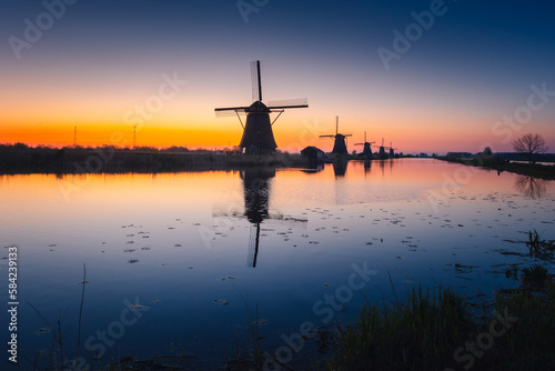 Morning among the windmills in Kinderdijk - one of the most characteristic places in the Netherlands. The beautiful spring adds charm to this place.