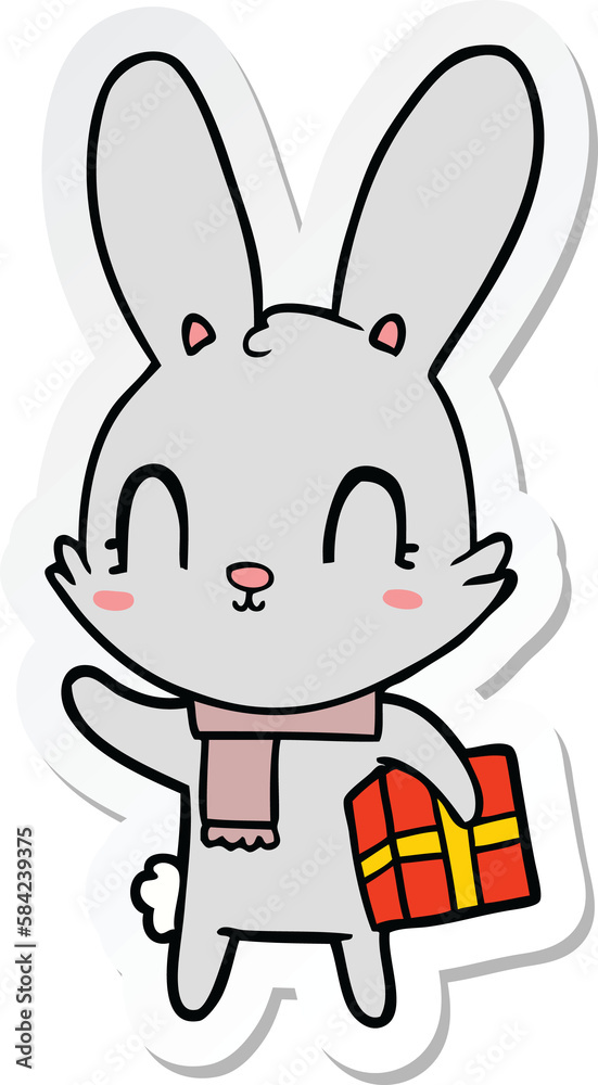 sticker of a cute cartoon rabbit with christmas present sticker of a cute cartoon rabbit with christmas present