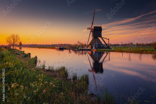 Morning among the windmills in Kinderdijk - one of the most characteristic places in the Netherlands. The beautiful spring adds charm to this place.