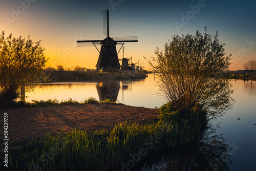 Morning among the windmills in Kinderdijk - one of the most characteristic places in the Netherlands. The beautiful spring adds charm to this place.