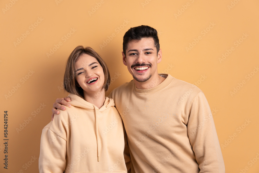 joyful couple smiling and looking at camera in studio shot. joy, people concept. joyful couple smiling and looking at camera in studio shot. joy, people concept.