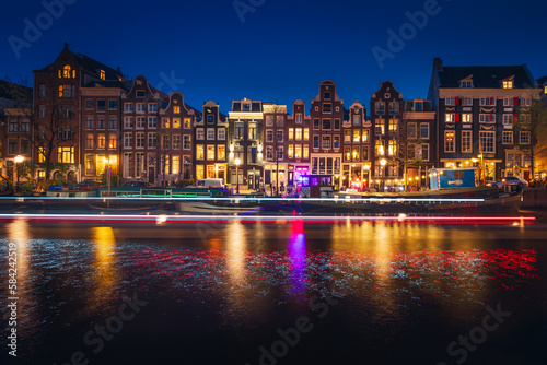 Canals in Amsterdam - the capital of the Netherlands in a night scenery. The huge amount of colors adds a beautiful look to this architecture.