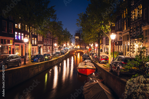 Canvas Print Canals in Amsterdam - the capital of the Netherlands in a night scenery