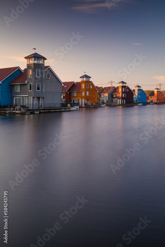 Colorful houses in Groningen during the blue hour. The original architecture of the houses is a frequent reason for visiting this place.