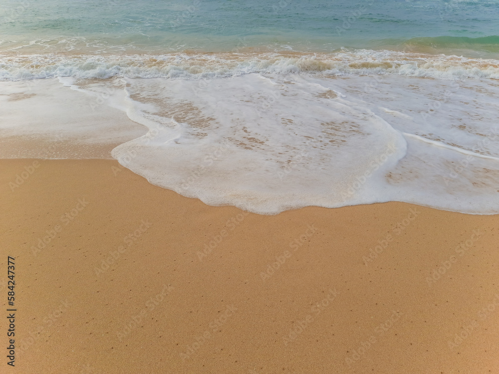 Beautiful sand beach and turquoise water. Summer holiday beach background. Ocean waves on empty tropical sand beach. Vertical background Beautiful sand beach and turquoise water. Summer holiday beach background. Ocean waves on empty tropical sand beach. Vertical background