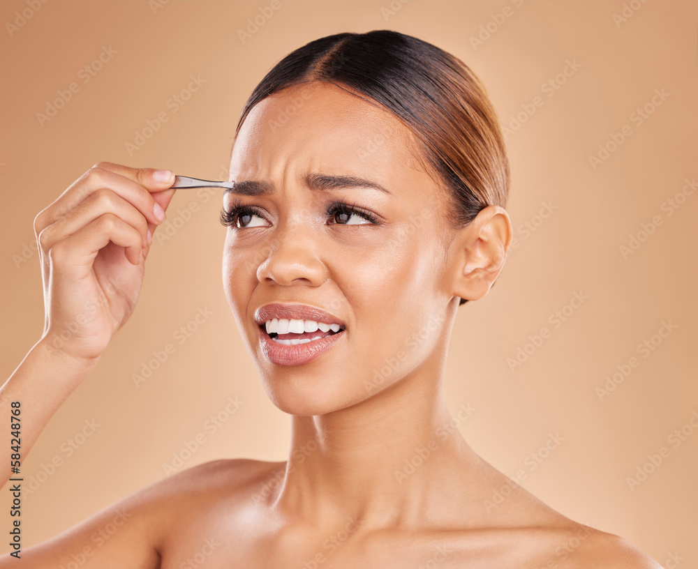 Beauty, pain and eyebrows with woman and tweezers in studio for clean, self care and cosmetics. Facial, plucking and shape with female model on brown background for hair removal, skincare or grooming Beauty, pain and eyebrows with woman and tweezers in studio for clean, self care and cosmetics. Facial, plucking and shape with female model on brown background for hair removal, skincare or grooming