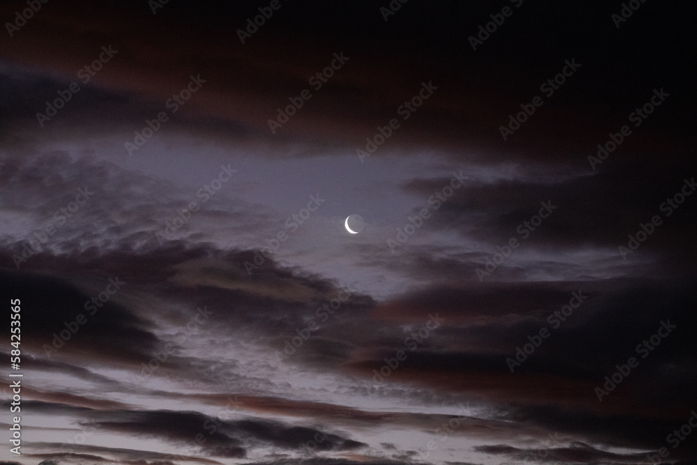 Crescent moon and clouds in night sky Crescent moon and clouds in night sky