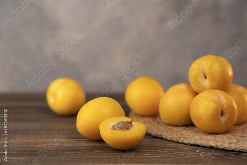 Yellow plums on a wood background. Fresh BIO fruits.