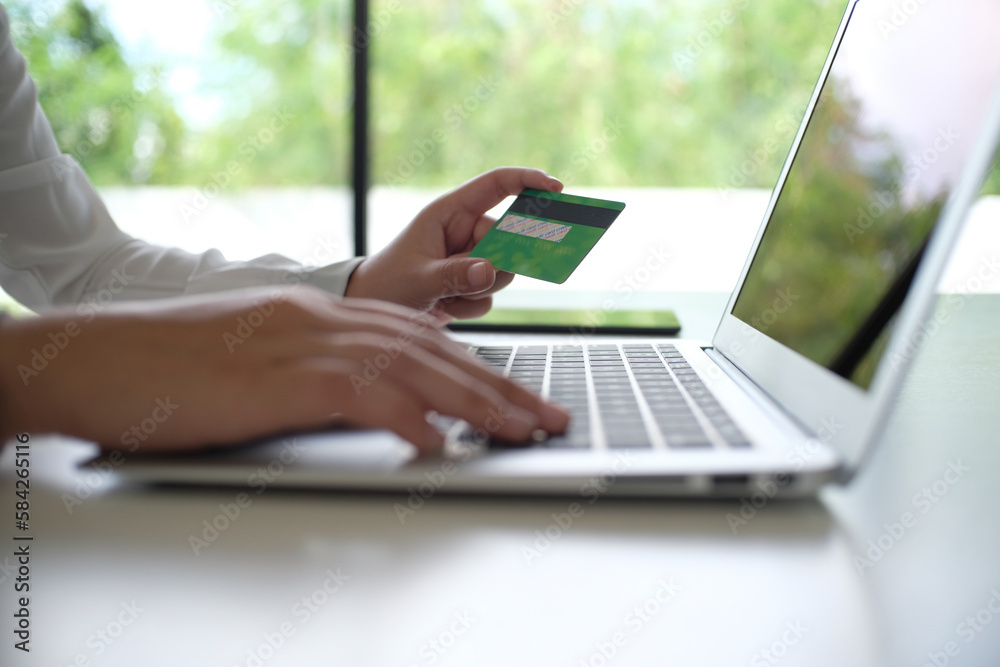 Business Woman Hands holding plastic credit card and using laptop smart phone Online shopping concept. Business Woman Hands holding plastic credit card and using laptop smart phone Online shopping concept.