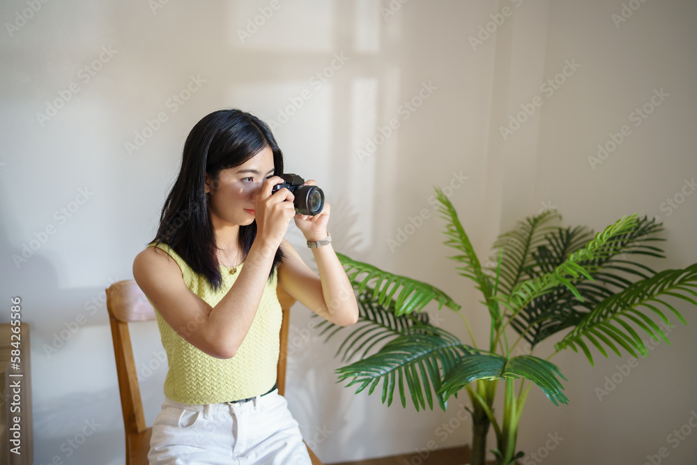 Happy young Asian Woman photographer holding camera Creative female freelancer working freelance creative artist