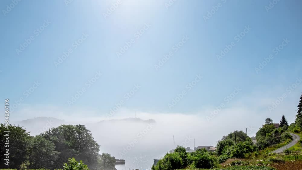 Time lapse of sea fog by the coast on a sunny day Time lapse of sea fog by the coast on a sunny day