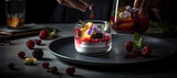 A glass of fruit with ice on top of a plate and other fruits on the table