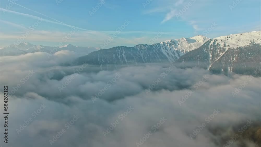 Drone flying over clouds with snowy mountains in background. Aerial forward and sky for copy space Drone flying over clouds with snowy mountains in background. Aerial forward and sky for copy space