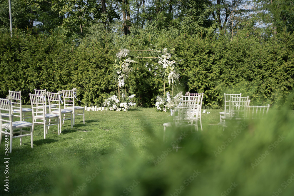 Beautiful Wedding ceremony event. Outdoor wedding arch. Green and white wedding decorations. Wedding day. Beautiful Wedding ceremony event. Outdoor wedding arch. Green and white wedding decorations. Wedding day.