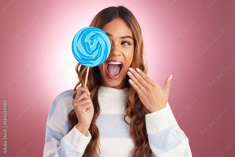Excited, woman and lollipop candy in a studio with a female feeling happiness from sweets. Smile, surprise and happy model with a sweet dessert treat with isolated pink background and sugar snack Excited, woman and lollipop candy in a studio with a female feeling happiness from sweets. Smile, surprise and happy model with a sweet dessert treat with isolated pink background and sugar snack