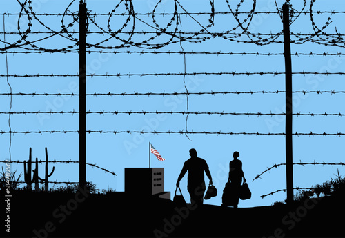 A man and woman are seen in silhouette after breaching a border fence on the southern border of the USA. They have gone through a broken barbed wire fence at mid-day. A USA flag can be seen in the dis