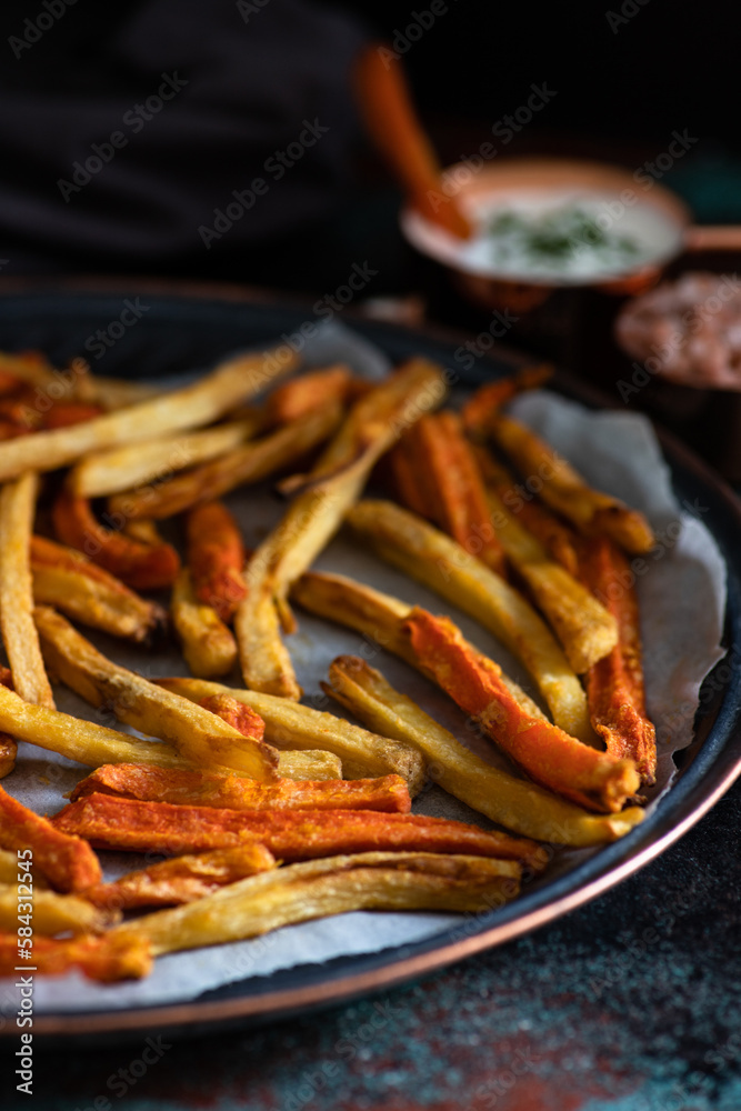 Healthy homemade oven baked sweet potato and carrot fries served with yogurt and green onion sauce. Low calorie vegetarian snack Healthy homemade oven baked sweet potato and carrot fries served with yogurt and green onion sauce. Low calorie vegetarian snack