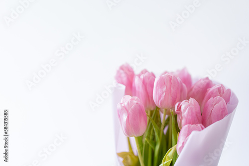 Fototapeta Naklejka Na Ścianę i Meble -  Pink tulips on a white background. Beautiful Card for Mother's Day or Women's Day.